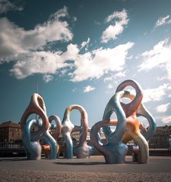 Low angle view of sculpture on street against sky