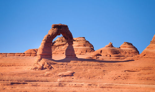 Rock formation in desert against clear blue sky