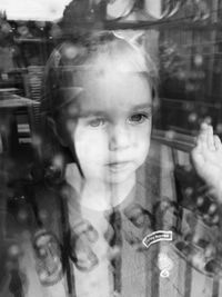 Portrait of a smiling girl in glass