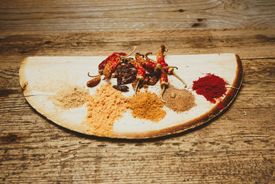 Spices and red chili peppers on table