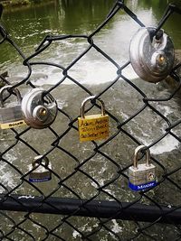 Close-up of padlocks on chainlink fence