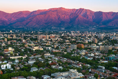 Aerial view of city against mountains