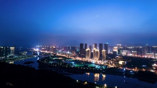 High angle view of illuminated buildings in city at night