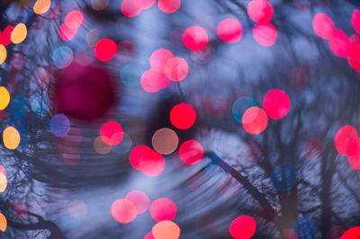 Double exposure of christmas lights and trees