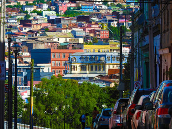Vehicles on street amidst buildings in city