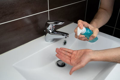 High angle view of baby feet in bathroom