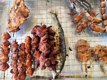 High angle view of meat on barbecue grill