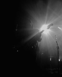 Low angle view of illuminated lighting equipment against sky