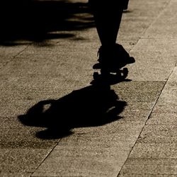 Low section of silhouette woman walking on floor