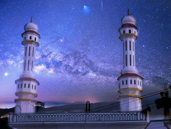 Low angle view of lighthouse against sky at night