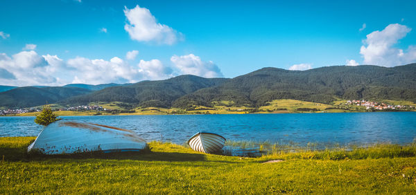 Scenic view of lake and mountains against sky