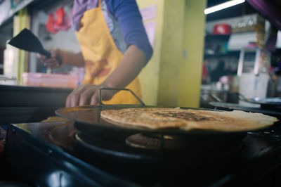 Midsection of chef making food in restaurant