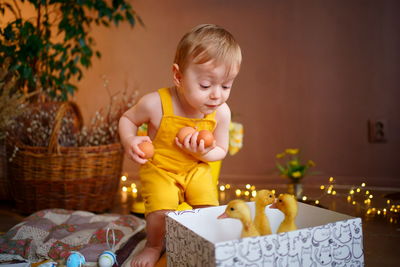 Easter, baby holding eggs, box with geese