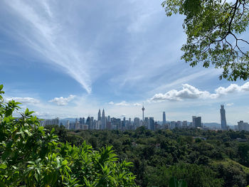 Panoramic view of trees and buildings against sky