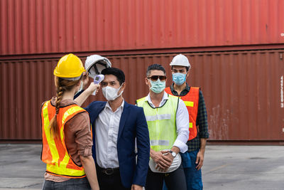 Rear view of worker checking temperature at commercial dock