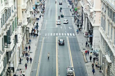 High angle view of people walking on road