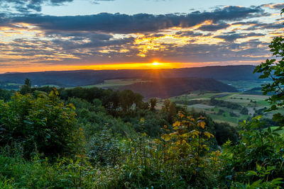 Scenic view of landscape against sky during sunset