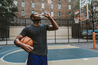 Full length of man playing basketball