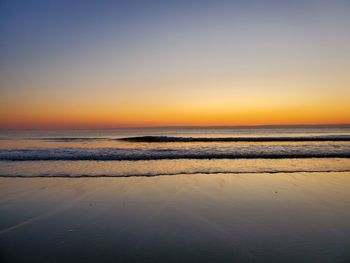 Scenic view of sea against clear sky during sunset