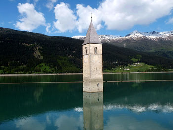 View of church in lake against sky