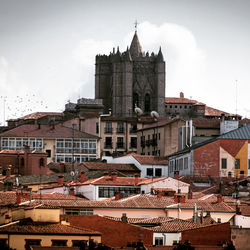 Buildings in town against sky