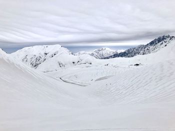 Scenic view of snow covered mountains against sky