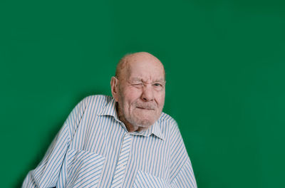 Portrait of man against green background