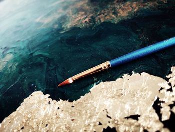 High angle view of colored pencils in water