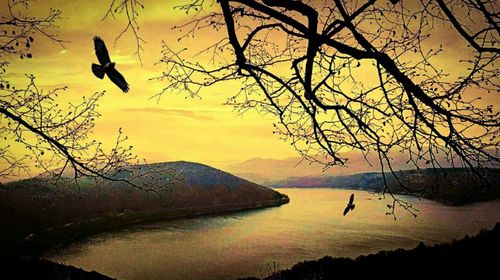 Scenic view of lake against sky during sunset