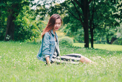 Full length of woman on grass in field