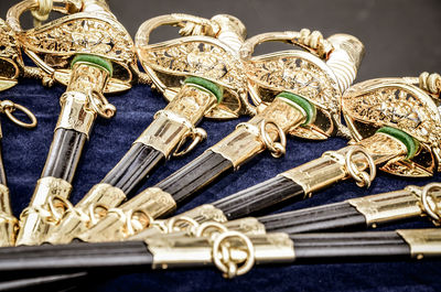 High angle close-up of swords on table