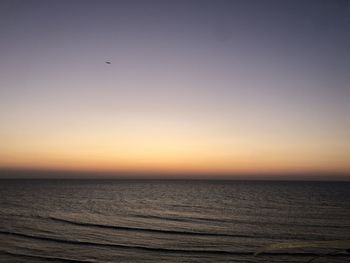 Scenic view of sea against clear sky during sunset