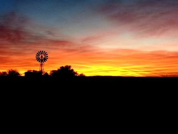 Silhouette landscape against sky during sunset