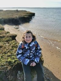 Portrait of young child standing at beach