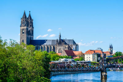 View of buildings by river in city