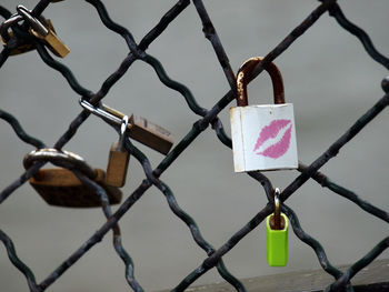 Padlocks with lipstick kiss attached on fence