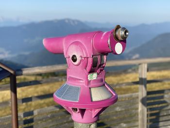Close-up of binoculars against sky