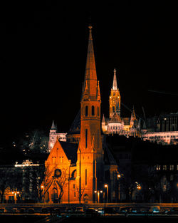 Illuminated buildings in city at night