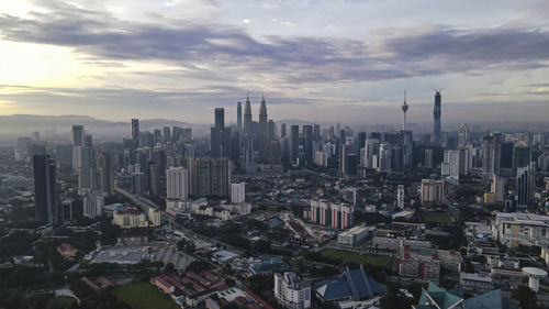 Aerial view of kuala lumpur, malaysia under early morning sun with slight haze. 