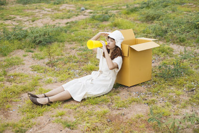 Woman with umbrella on field