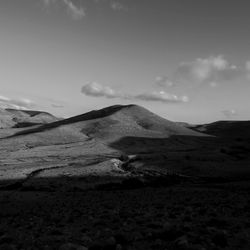 Scenic view of arid landscape against sky