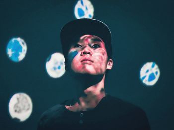 Portrait of man with bubble against black background