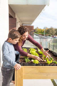 Mother and son working on a urban garden at home