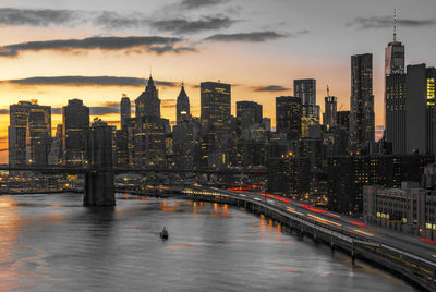 View of buildings at waterfront during sunset