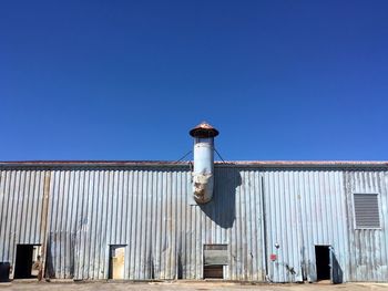 Built structures against clear blue sky