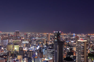 High angle view of illuminated city buildings against sky