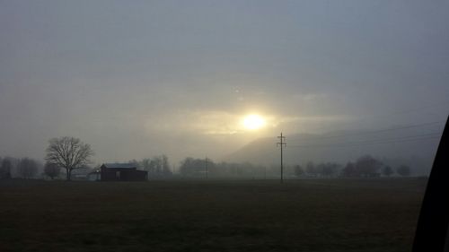 Scenic view of field against sky at sunset