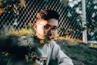 Portrait of young man holding flower