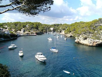 High angle view of sailboats moored on sea against sky