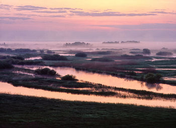 Scenic view of lake against sky during sunrise